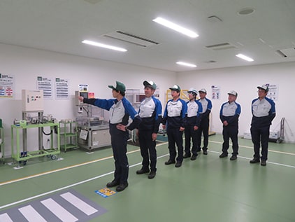 Practicing a pointing-and-calling procedure at a pedestrian crossing during a Safety Dojo training session